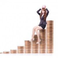 Happy business woman holding pink piggy bank and sitting on money stairs isolated against white background, business concept
